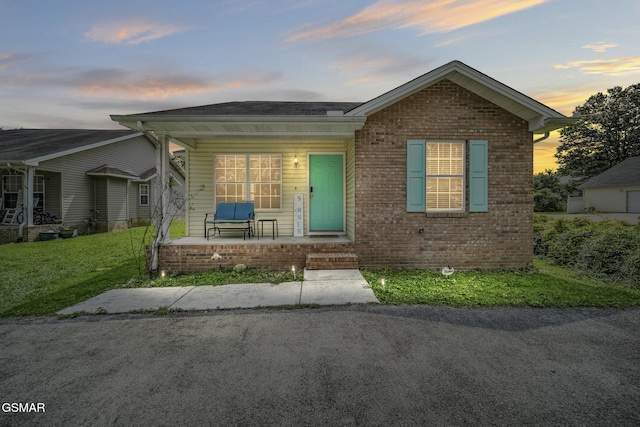 1733 Snapp Rd, Sevierville, TN 37862 - bungalow-style house with covered porch, brick siding, and a yard