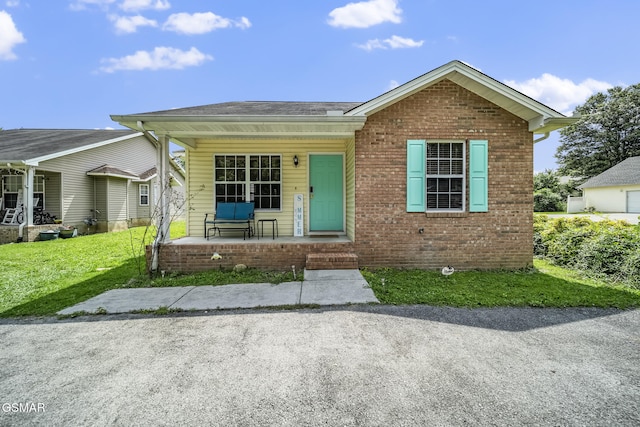 1733 Snapp Rd, Sevierville, TN 37862 - view of front of house featuring a porch, a front lawn, and brick siding