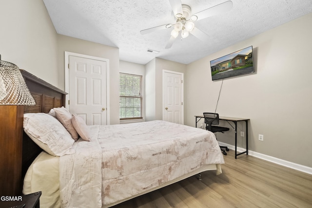 1733 Snapp Rd, Sevierville, TN 37862 - bedroom featuring wood finished floors, baseboards, a textured ceiling, and ceiling fan