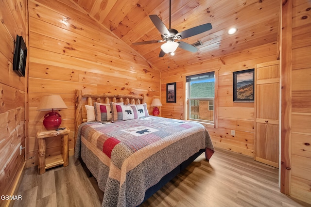 bedroom featuring wood walls, wooden ceiling, vaulted ceiling, hardwood / wood-style flooring, and ceiling fan