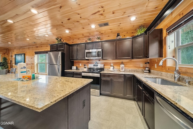 kitchen featuring light stone counters, sink, and appliances with stainless steel finishes