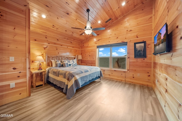 bedroom with wood walls, lofted ceiling, hardwood / wood-style flooring, ceiling fan, and wood ceiling