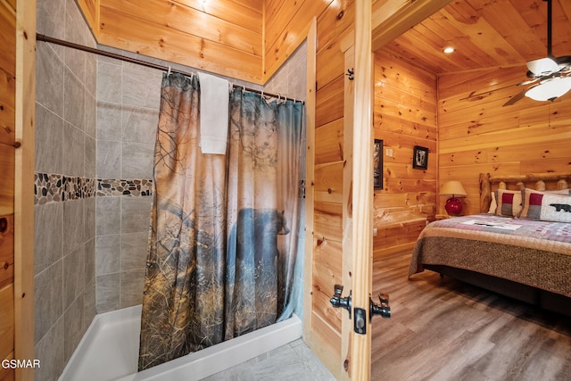 bedroom featuring wooden ceiling, ceiling fan, and wooden walls