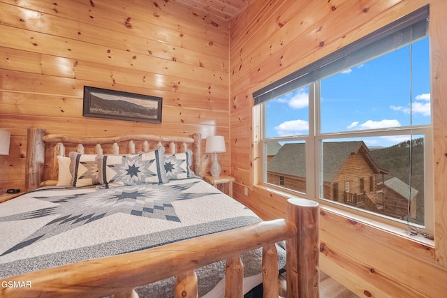 bedroom featuring wood walls