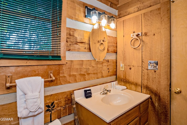 bathroom with wood walls and vanity