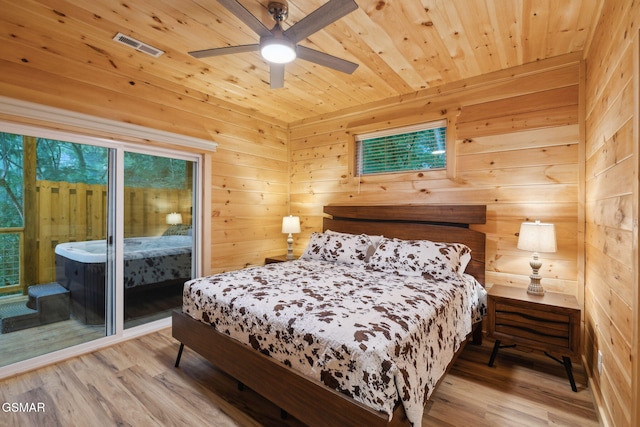 1010 Pinyon Cir, Pigeon Forge, TN 37863 - bedroom featuring access to exterior, wood finished floors, wooden ceiling, wooden walls, and a ceiling fan