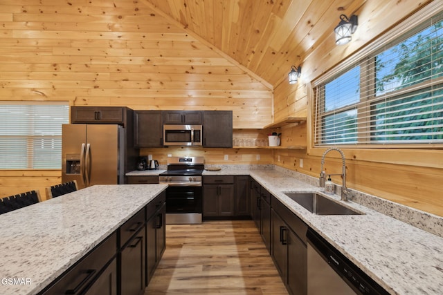 1010 Pinyon Cir, Pigeon Forge, TN 37863 - kitchen with stainless steel appliances, wooden ceiling, wood walls, open shelves, and light wood-style flooring