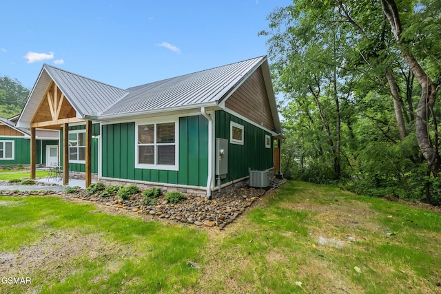 1010 Pinyon Cir, Pigeon Forge, TN 37863 - view of property exterior featuring board and batten siding, a metal roof, a standing seam roof, and a yard