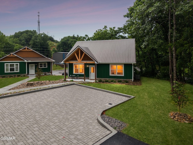 1010 Pinyon Cir, Pigeon Forge, TN 37863 - view of front of property featuring a metal roof, a porch, a lawn, and board and batten siding