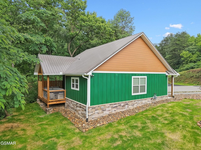 1010 Pinyon Cir, Pigeon Forge, TN 37863 - view of side of home with a yard, board and batten siding, a metal roof, and a deck