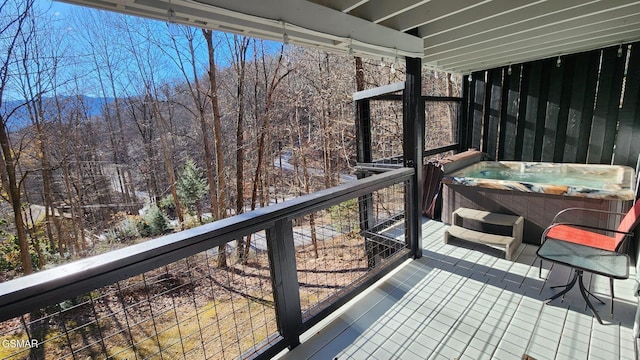 wooden deck with a hot tub