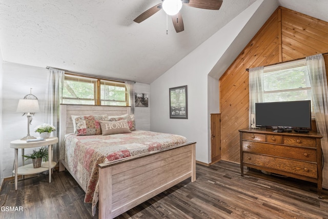 1514 Ridgecrest Dr, Sevierville, TN 37876 - bedroom featuring vaulted ceiling, wood walls, dark wood-style floors, a textured ceiling, and baseboards