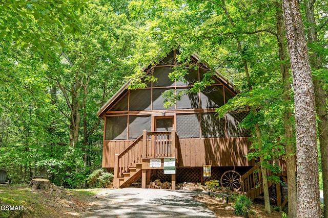 1514 Ridgecrest Dr, Sevierville, TN 37876 - rustic home with stairs, a sunroom, and a wooden deck