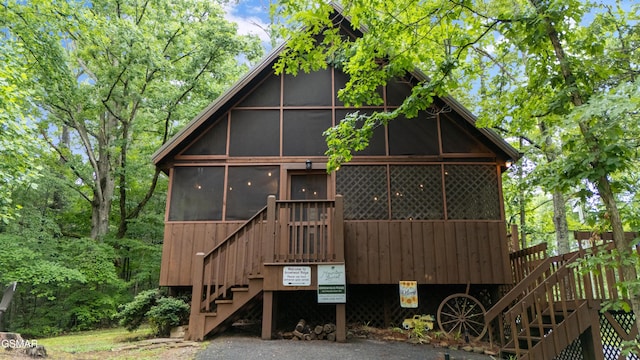 1514 Ridgecrest Dr, Sevierville, TN 37876 - rear view of property with stairs and a sunroom