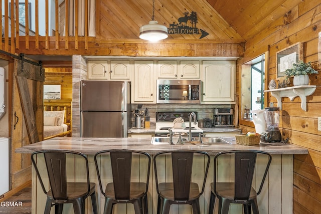 1514 Ridgecrest Dr, Sevierville, TN 37876 - kitchen featuring appliances with stainless steel finishes, wood walls, wooden ceiling, estacked washer and dryer, and a sink
