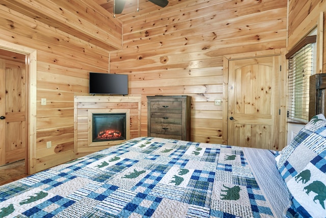 bedroom featuring ceiling fan and wooden walls