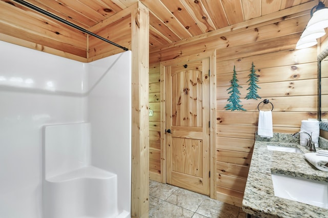 bathroom featuring a shower, vanity, wooden walls, and wood ceiling