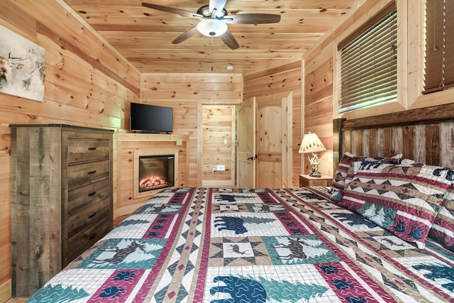 bedroom with ceiling fan, wood walls, and wood ceiling