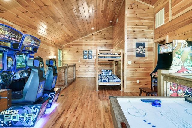 bedroom with lofted ceiling, wood-type flooring, wood ceiling, and wooden walls