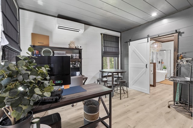 441 Matterhorn Dr, Gatlinburg, TN 37738 - home office featuring a barn door, light hardwood / wood-style floors, a wall mounted AC, and wood walls