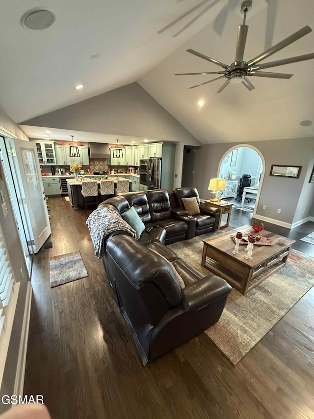 2530 Goingback Cir, Sevierville, TN 37876 - living room featuring lofted ceiling, dark wood-type flooring, ceiling fan, arched walkways, and baseboards