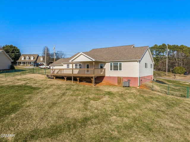 back of property with a lawn, central air condition unit, and a wooden deck