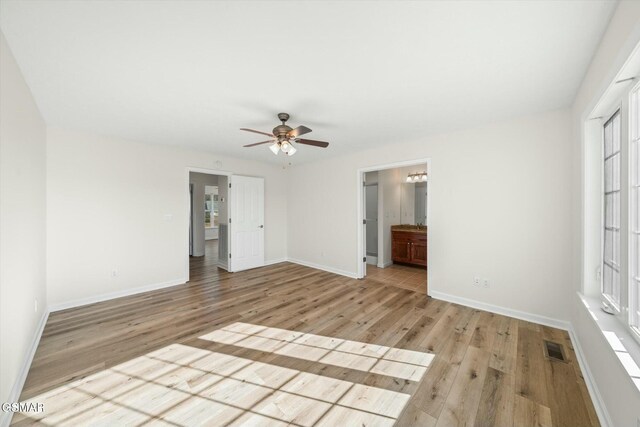 spare room featuring light hardwood / wood-style floors and ceiling fan