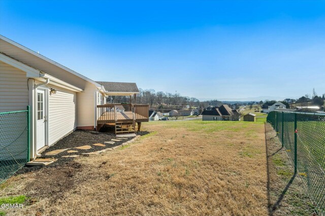 view of yard with a storage unit and a deck