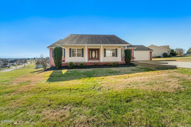 single story home with a garage, covered porch, and a front yard