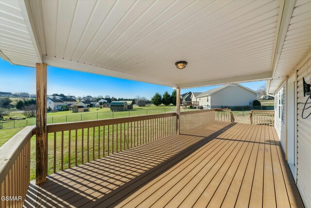 wooden terrace with a lawn