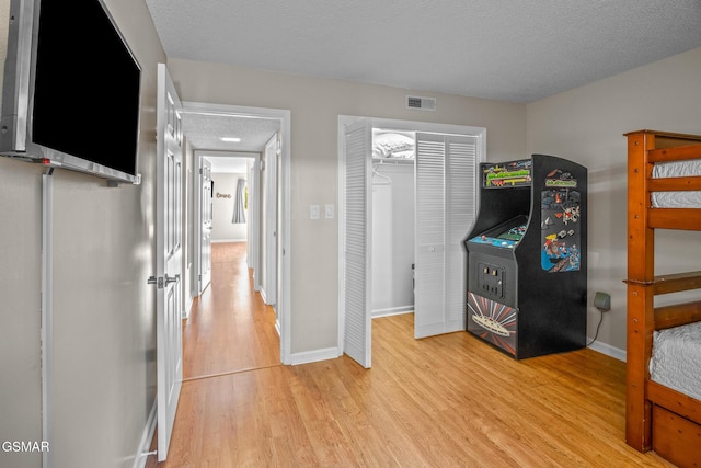 526 Briarcliff Way Apt 102, Pigeon Forge, TN 37863 - unfurnished bedroom with light wood-style flooring, a textured ceiling, and a closet