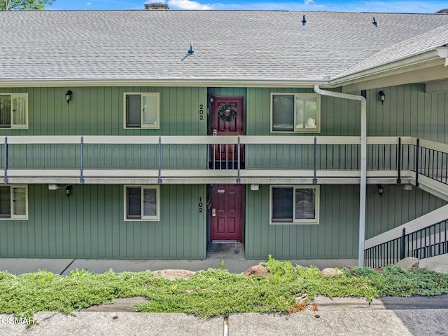 526 Briarcliff Way Apt 102, Pigeon Forge, TN 37863 - view of front of home with a balcony, a shingled roof, and a chimney
