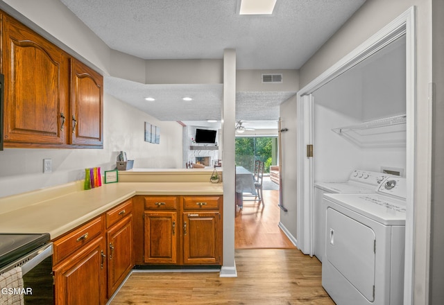 526 Briarcliff Way Apt 102, Pigeon Forge, TN 37863 - kitchen featuring a textured ceiling, light wood-type flooring, light countertops, ceiling fan, and brown cabinets
