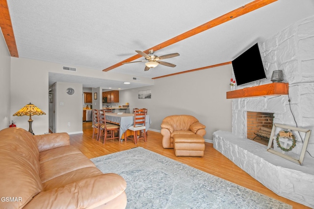 526 Briarcliff Way Apt 102, Pigeon Forge, TN 37863 - living area featuring ceiling fan, wood finished floors, and a stone fireplace