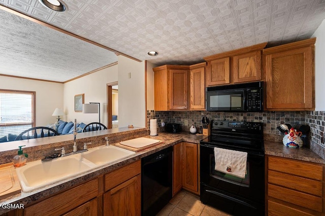 kitchen featuring decorative backsplash, crown molding, sink, black appliances, and light tile patterned flooring