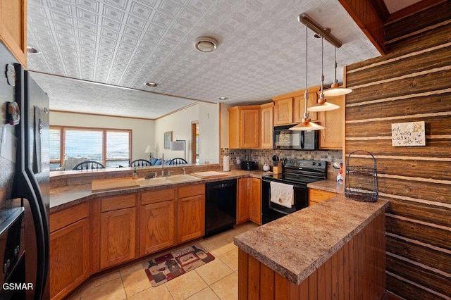 kitchen featuring black appliances, pendant lighting, kitchen peninsula, and light tile patterned floors