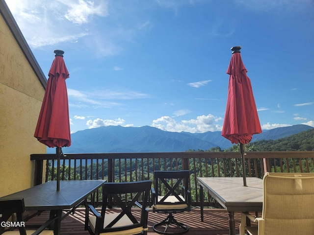 wooden deck with a mountain view