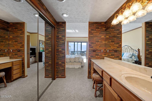 bathroom featuring vanity, a textured ceiling, and ornamental molding