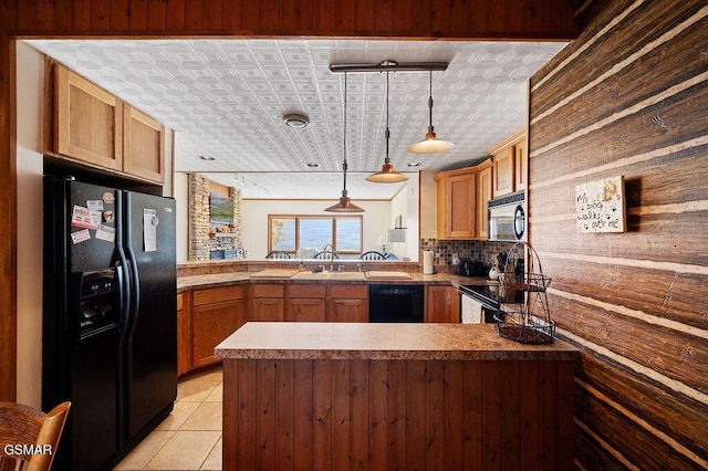 kitchen featuring kitchen peninsula, tasteful backsplash, black appliances, hanging light fixtures, and light tile patterned flooring