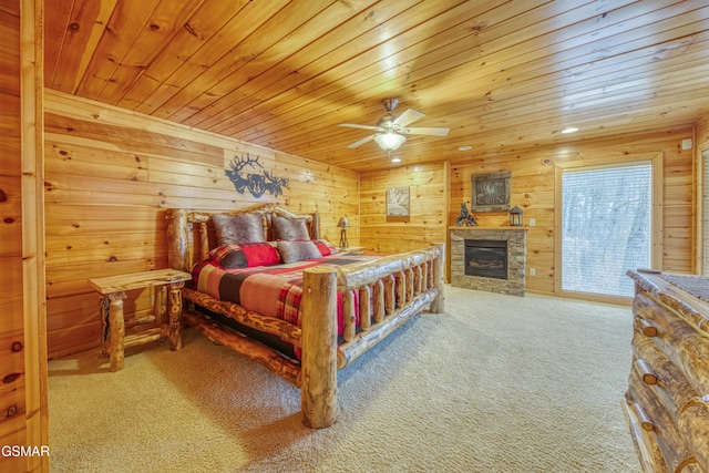 bedroom featuring ceiling fan, wooden ceiling, access to outside, a fireplace, and carpet flooring