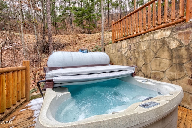 view of pool featuring a deck and a hot tub