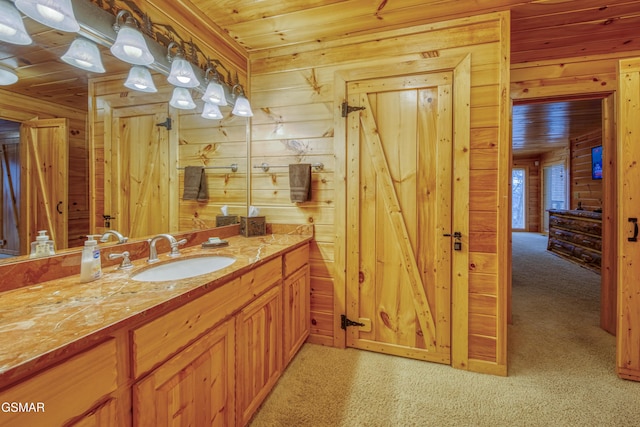 bathroom featuring wood ceiling, wood walls, and vanity