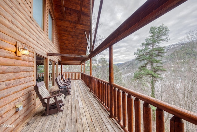 wooden deck with a mountain view