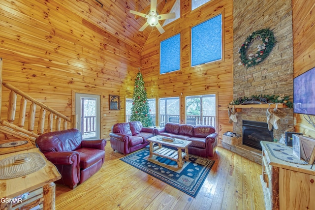 living room featuring wood-type flooring, plenty of natural light, and high vaulted ceiling