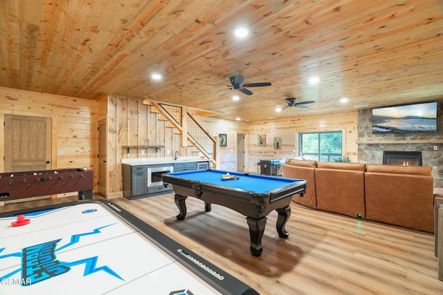 playroom featuring wood walls, wood ceiling, a fireplace, and billiards