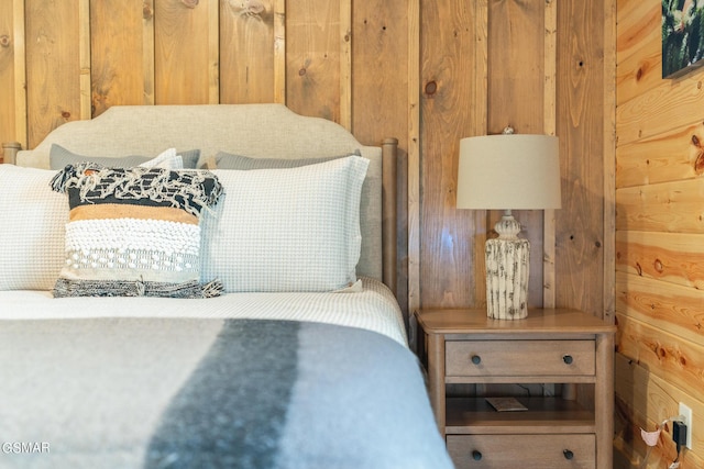 bedroom with wood walls