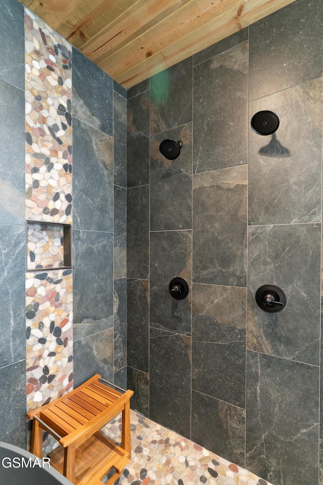 bathroom featuring wooden ceiling and tiled shower