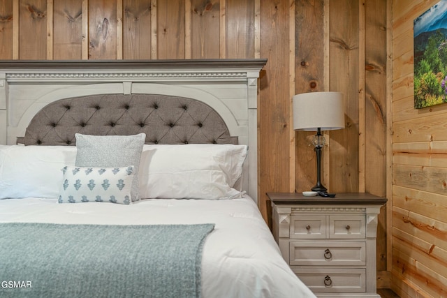 bedroom featuring wood walls