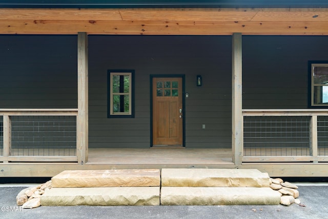 view of exterior entry featuring a porch