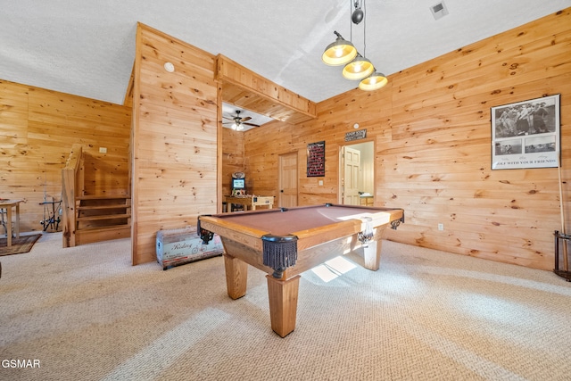 rec room with carpet, a textured ceiling, ceiling fan, billiards, and wood walls